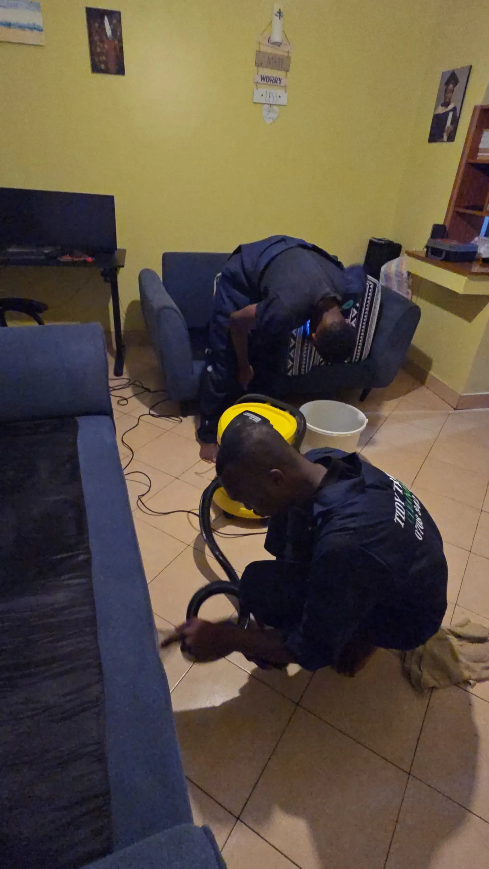 Working along the sofa arm with the extraction nozzle