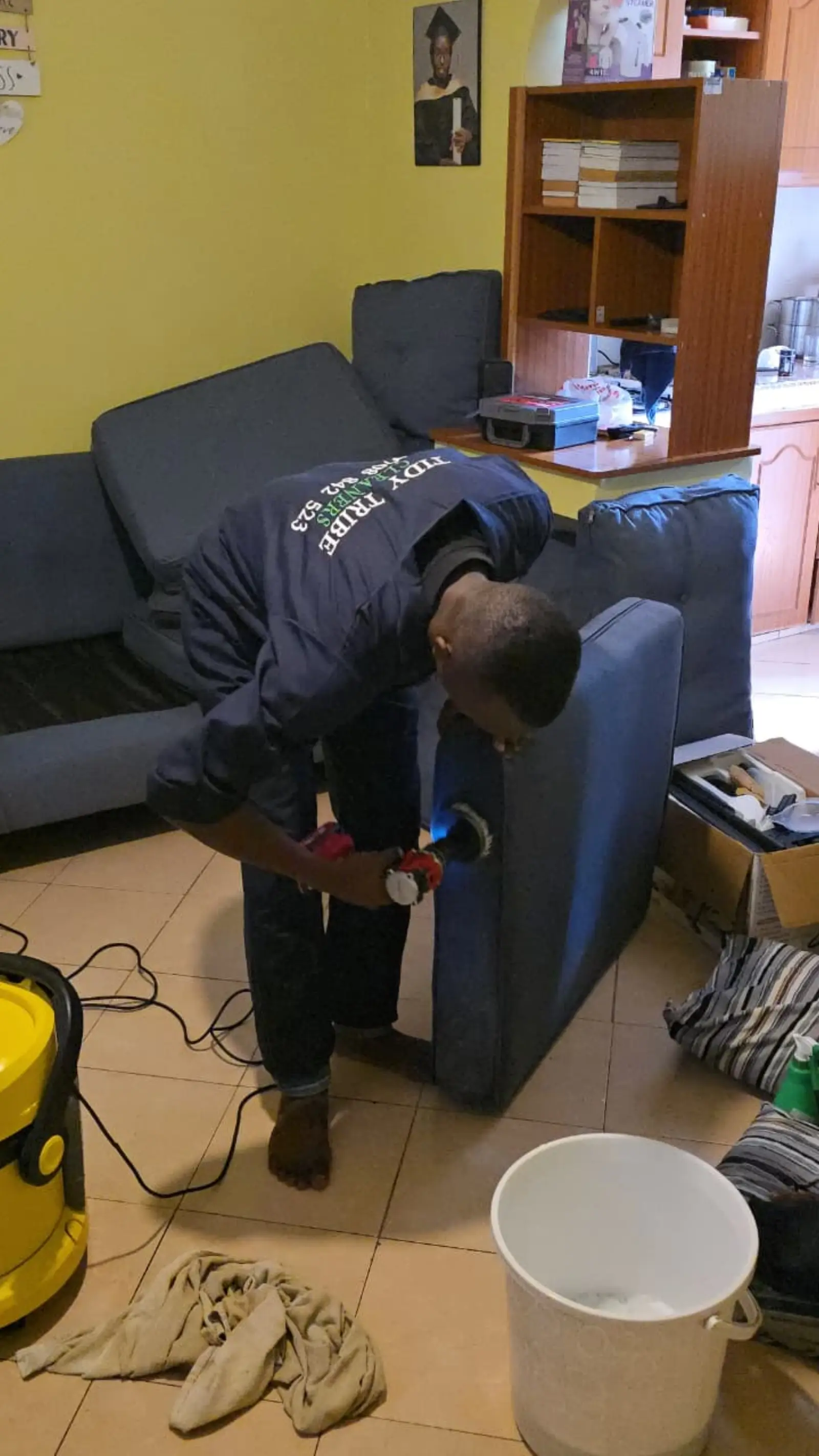 Sofa arm and side panel being cleaned by hand