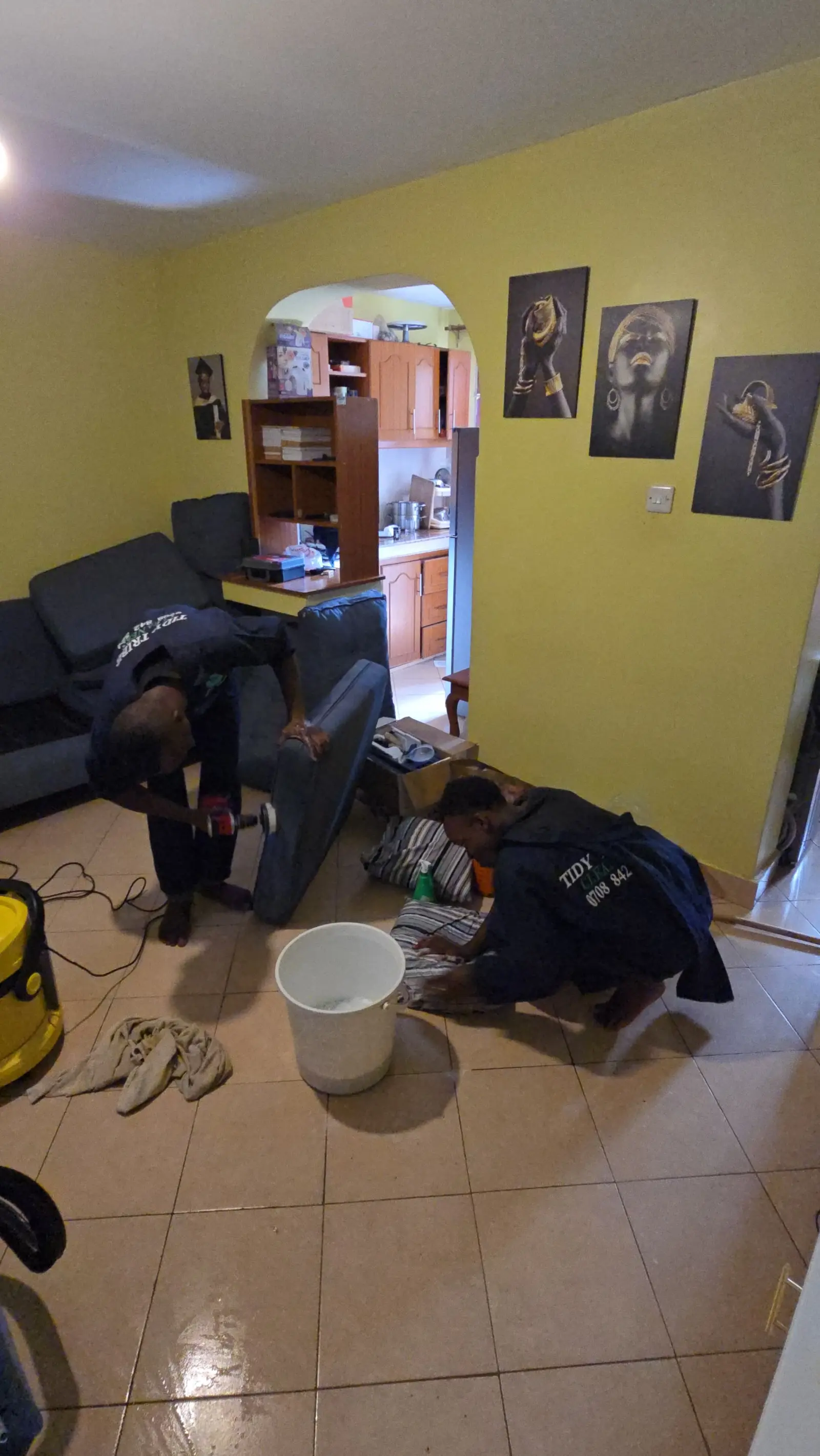 Cleaning a corner sofa in a Nairobi apartment