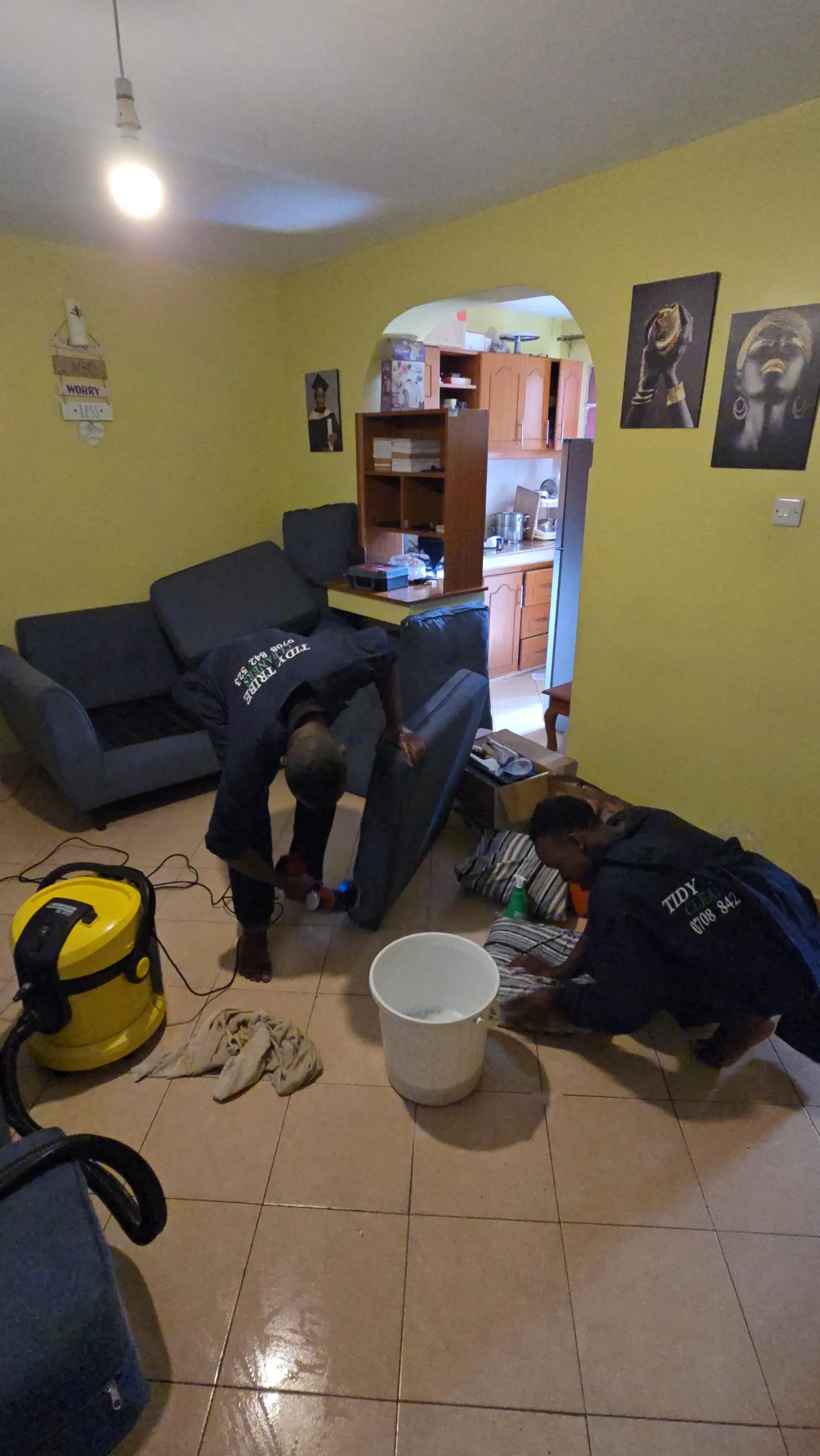 Cleaner working on floor-level detail during a general clean