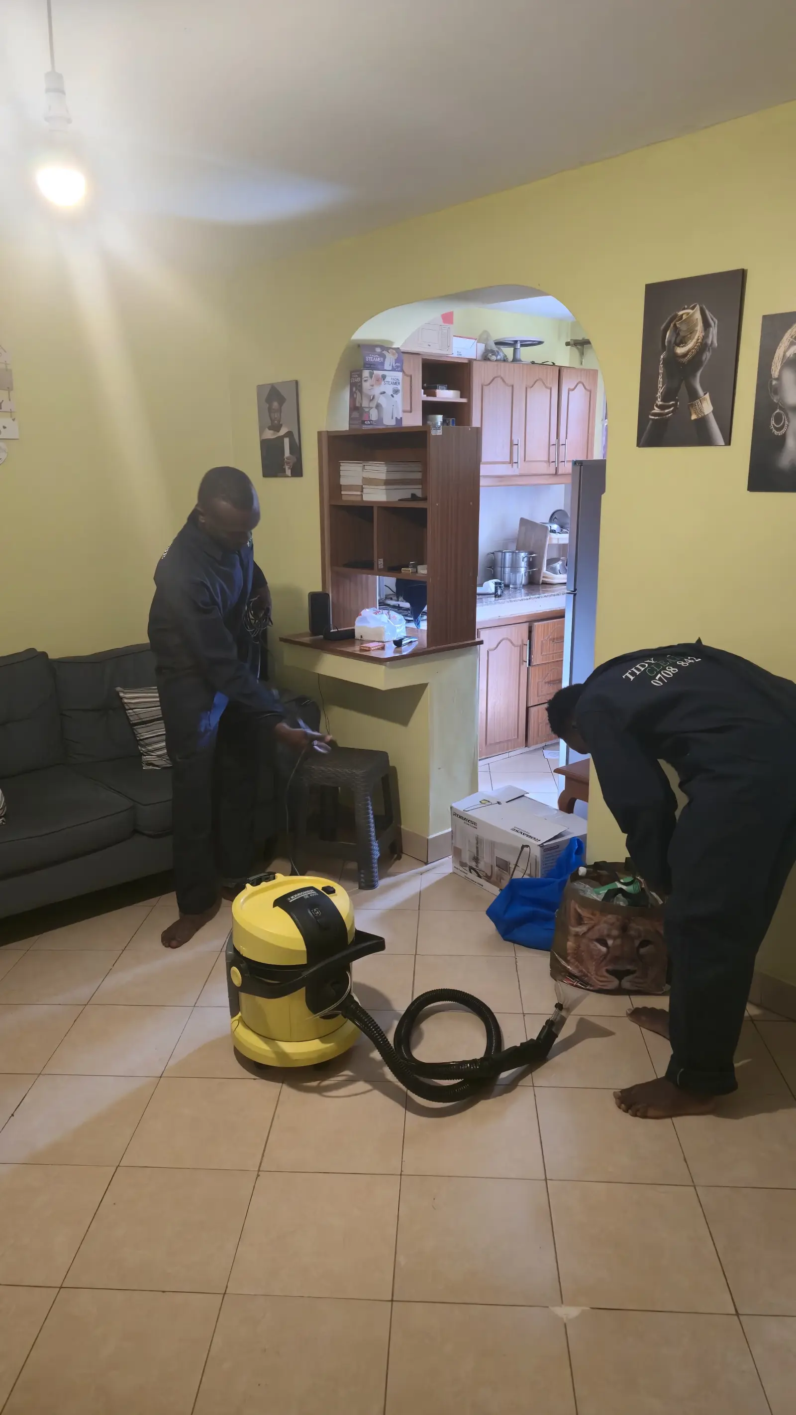 Living room mid-clean with equipment set up