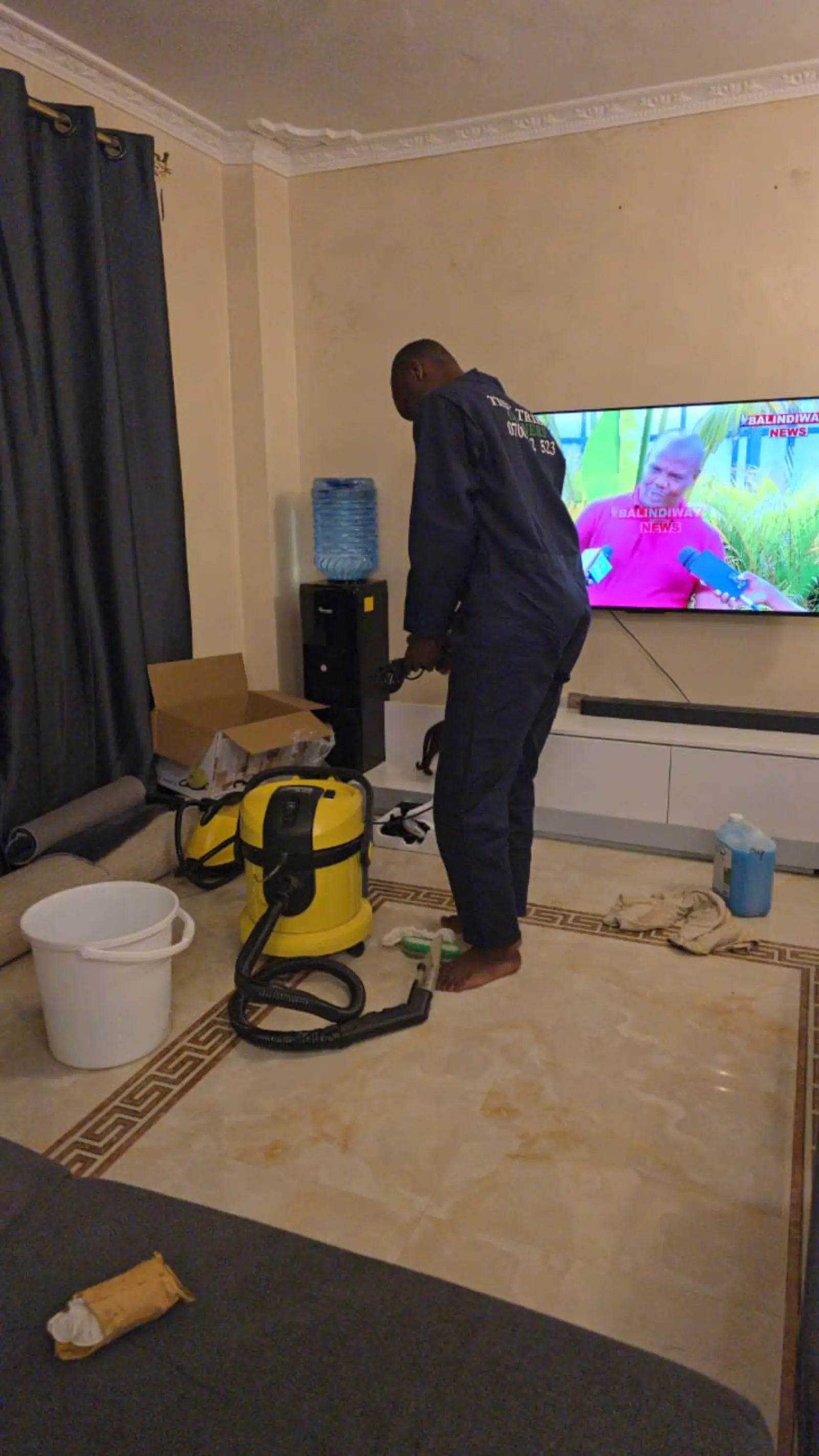 Ottoman being cleaned beside the TV unit